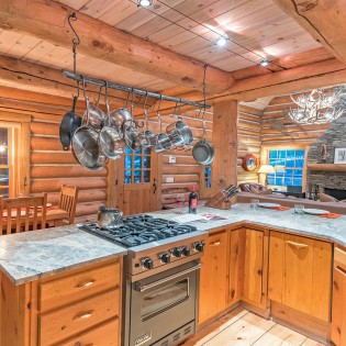 mountain village vacation rental yellow brick cabin kitchen to dining