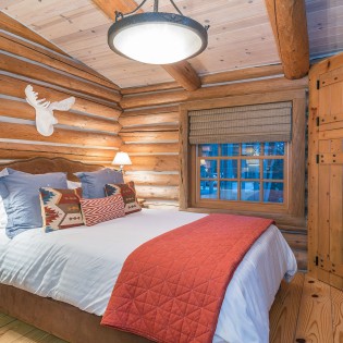 mountain village vacation rental yellow brick cabin master bedroom