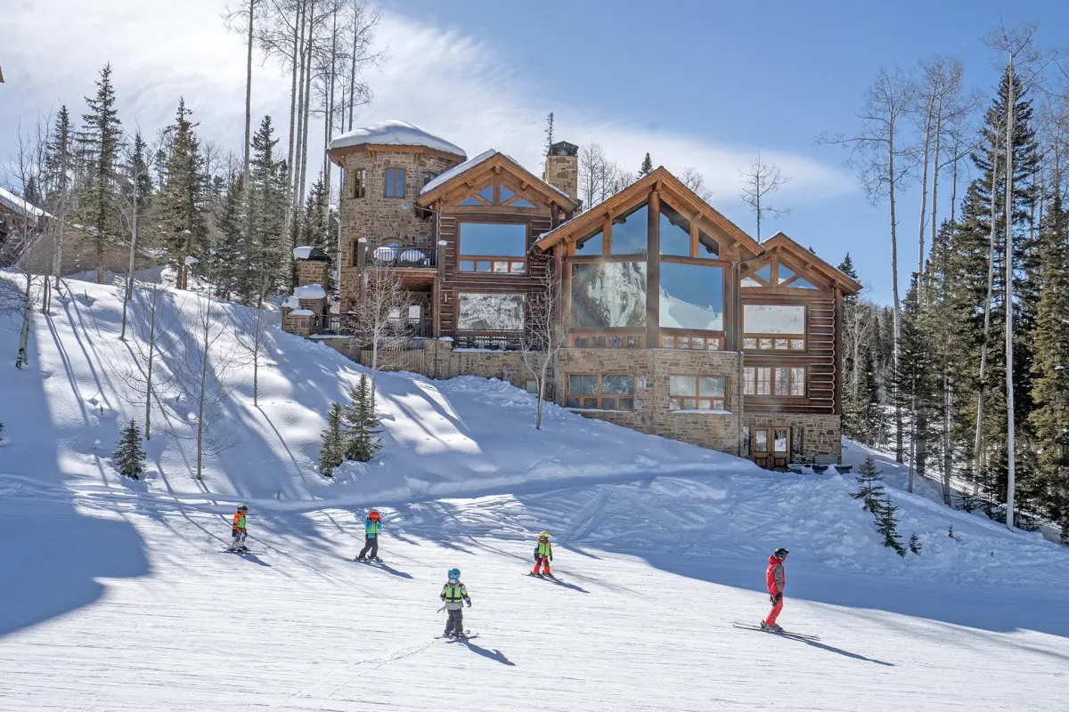 Ski-in, ski-out Telluride vacation rental with guests accessing slopes directly from property, showcasing ultimate skiing convenience