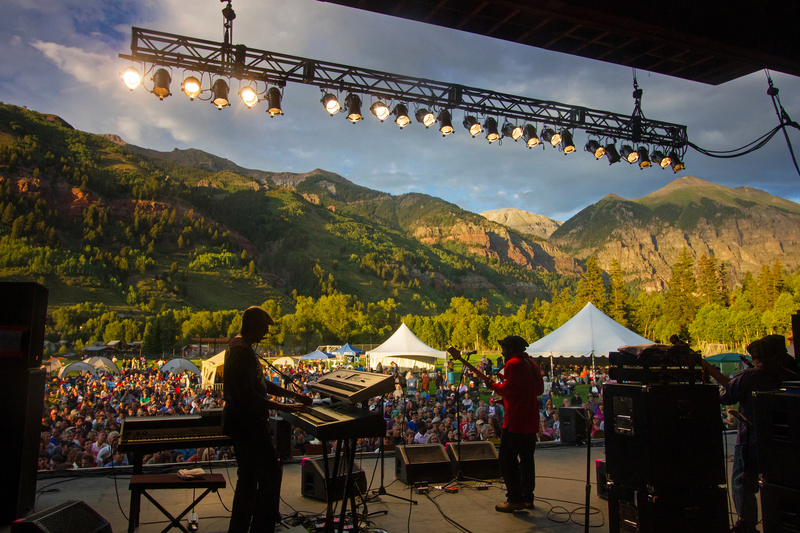 Telluride festival atmosphere featuring live performance with enthusiastic audience and spectacular mountain scenery